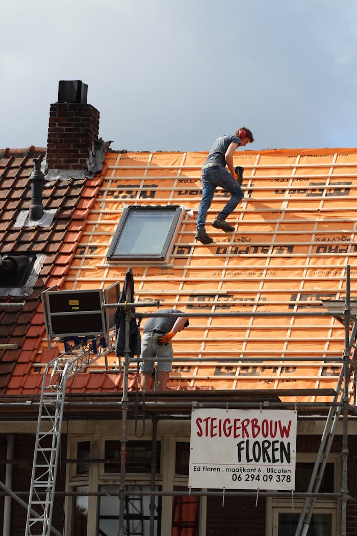 Construction workers installing new roof tiles in the Netherlands.